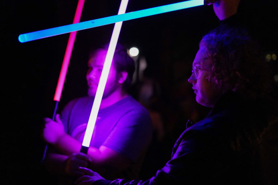 Mike Thompson (left) and Williams Atkinson, the two leaders of the Lexington Lightsaber League, ready their weapons on Wednesday, Oct. 27, 2021, at Woodland Park in Lexington, Kentucky. Thompson and Atkinson are the two members that have been a part of the league for the longest. Photo by Kaitlyn Skaggs | Staff