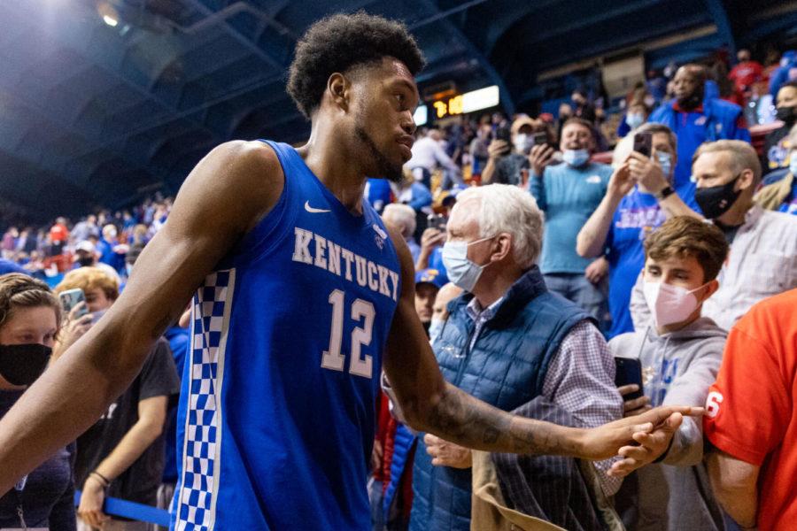 Kentucky Wildcats forward Keion Brooks Jr. (12) high fives a fan as he walks off the court after the UK vs. Kansas basketball game on Saturday, Jan. 29, 2022, at Allen Fieldhouse in Lawrence, Kansas. UK won 80-62. Photo by Jack Weaver | Staff