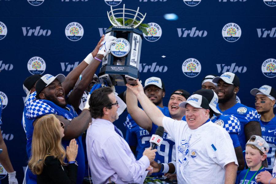 Kentucky Wildcats head coach Mark Stoops holds up the trophy after the UK vs Iowa VRBO Citrus Bowl football game on Saturday, Jan. 1, 2022, at Camping World Stadium in Orlando, Florida. UK won 20-17. Photo by Michael Clubb | Staff