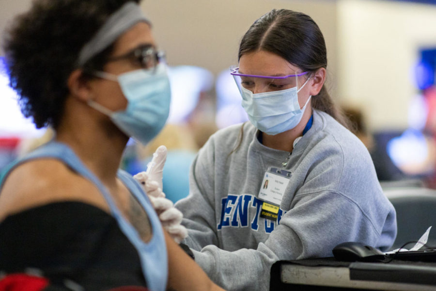 Holly Fessel, a UK nursing student, administers a dose of the Pfizer COVID-19 vaccine on Saturday, April 10, 2021, at UK’s COVID-19 vaccination clinic at Kroger Field in Lexington, Kentucky. Photo by Jack Weaver | Staff