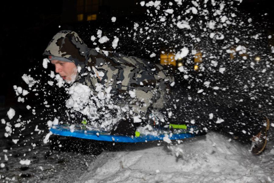 Sam Tipton, a sophomore civil engineering major, sleds down “The Bowl” at William T. Young Library during the first snowfall of the semester on Sunday, Jan. 16, 2022, at the University of Kentucky in Lexington, Kentucky. Photo by Jack Weaver | Staff