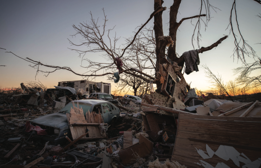 A car sits among the remains of a destroyed house after a tornado in Dawson Springs, Kentucky, Sunday, Dec. 12, 2021. AP Photo/Michael Clubb