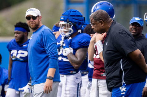 Kentucky offensive coordinator Liam Coen looks over to Kentucky assistant head coach Vince Marrow during an open practice in Lexington, Ky., Tuesday, Aug. 17, 2021. (AP Photo/Michael Clubb)