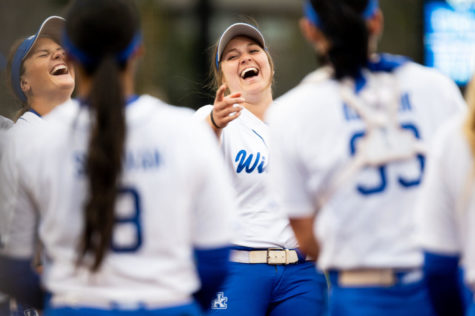 Kentucky infielder Emmy Blane (25) laughs with her teammates before the UK vs. Oklahoma softball game on Tuesday, March 22, 2022, at John Cropp Stadium in Lexington, Kentucky. Oklahoma won 9-1. Photo by Jack Weaver | Staff