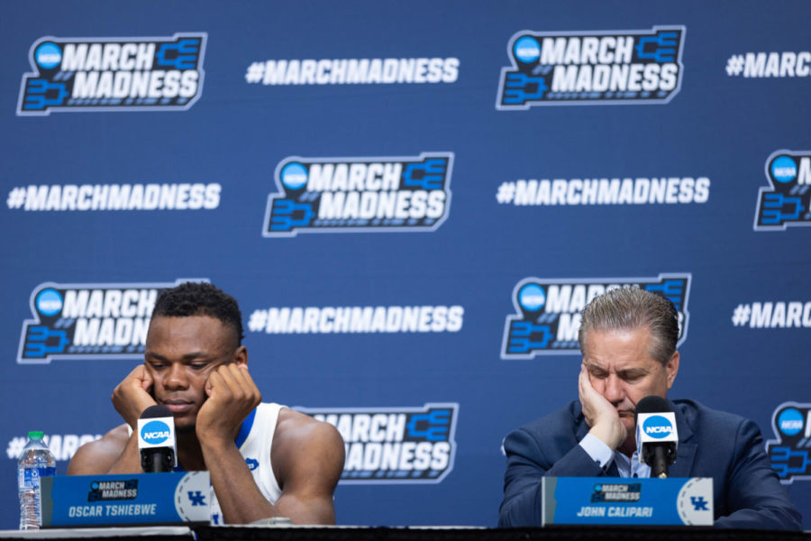Kentucky Wildcats forward Oscar Tshiebwe, left, and head coach John Calipari, right, hold their heads in their hands during a press conference after the UK vs. Saint Peter’s mens basketball game in the first round of the NCAA Tournament on Thursday, March 17, 2022, at Gainbridge Arena in Indianapolis, Indiana. UK lost 85-79 in overtime. Photo by Michael Clubb | Staff