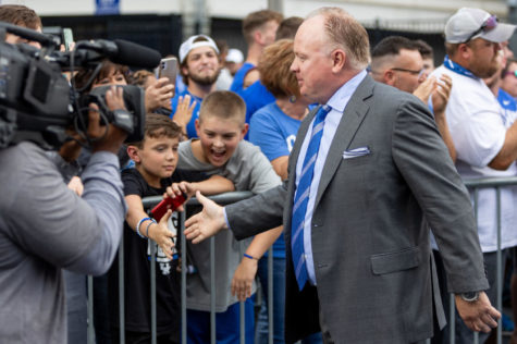 Kentucky head coach Mark Stoops high fives fans during the Cat Walk before the University of Kentucky vs. Florida football game on Saturday, Oct. 2, 2021, at Kroger Field in Lexington, Kentucky. Photo by Jack Weaver | Staff