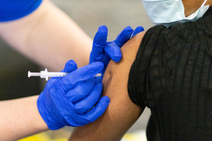 A dose of the Pfizer COVID-19 vaccine is injected into a patient’s arm on Saturday, April 10, 2021, at UK’s COVID-19 vaccination clinic at Kroger Field in Lexington, Kentucky. Photo by Jack Weaver | Staff