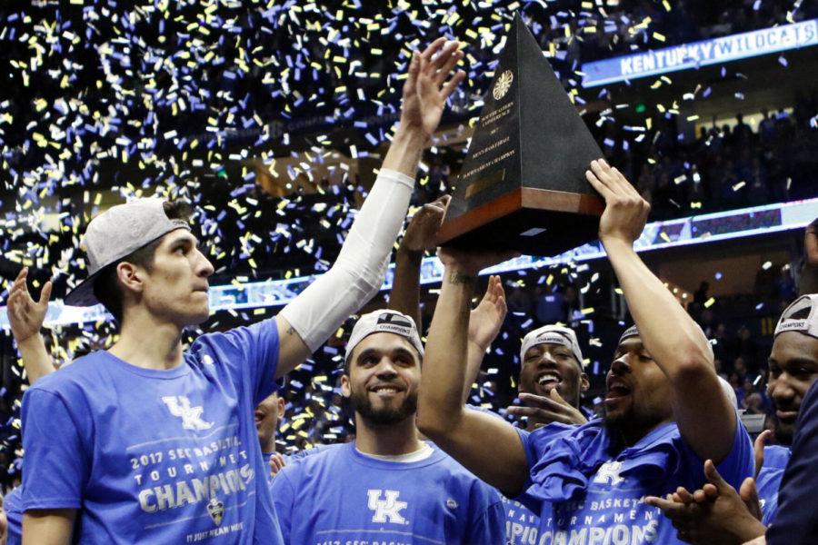 The Kentucky Wildcats mens basketball team holds up their trophy after the SEC Championship game against the Arkansas Razorbacks on Sunday, March 12, 2017, in Nashville, Tennessee.
