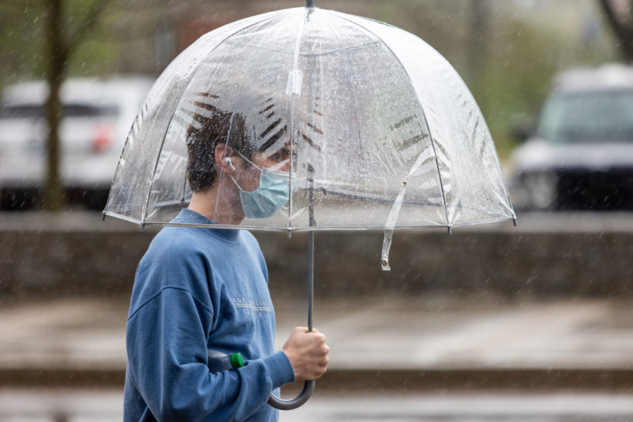 A UK student walks through the rain on Saturday, April 10, 2021, at the University of Kentucky in Lexington, Kentucky. Photo by Jack Weaver | Staff