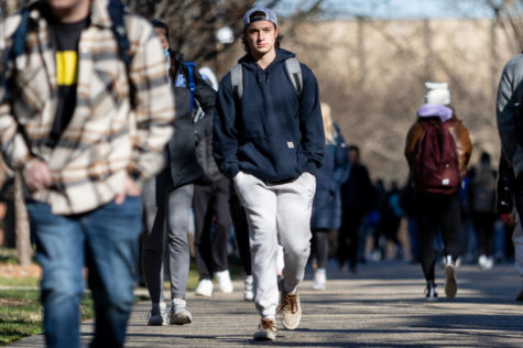 A student walks across campus on the first day of the spring semester on Monday, Jan. 10, 2022, at the University of Kentucky in Lexington, Kentucky. Photo by Jack Weaver | Staff