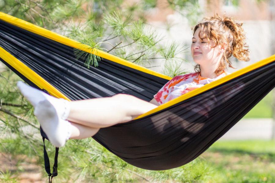 Vendela Norris, a freshman broadcast journalism major, sits in a hammock on Friday, April 9, 2021, outside William T. Young Library in Lexington, Kentucky. Photo by Jack Weaver | Staff
