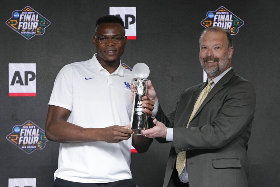 Oscar Tshiebwe of Kentucky, left, is introduced as The Associated Press mens basketball player of the year, by Barry Bedlan, AP global director of text and new markets products, in New Orleans, Friday, April 1, 2022. The 6-foot-9, 255-pound junior received 46 of 60 votes from a national media panel. Wisconsins Johnny Davis was second with 10 votes. (AP Photo/Gerald Herbert)