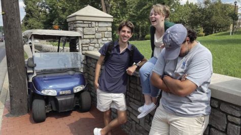 Jack Weaver, Rayleigh Deaton and Michael Clubb, left to right, wait for maintenance to tow the Kernels golf cart out from between a utility pole and a brick wall after Clubb got the golf cart stuck on Monday, Sept. 13, 2022, in front of Scovell Hall in Lexington, Kentucky.