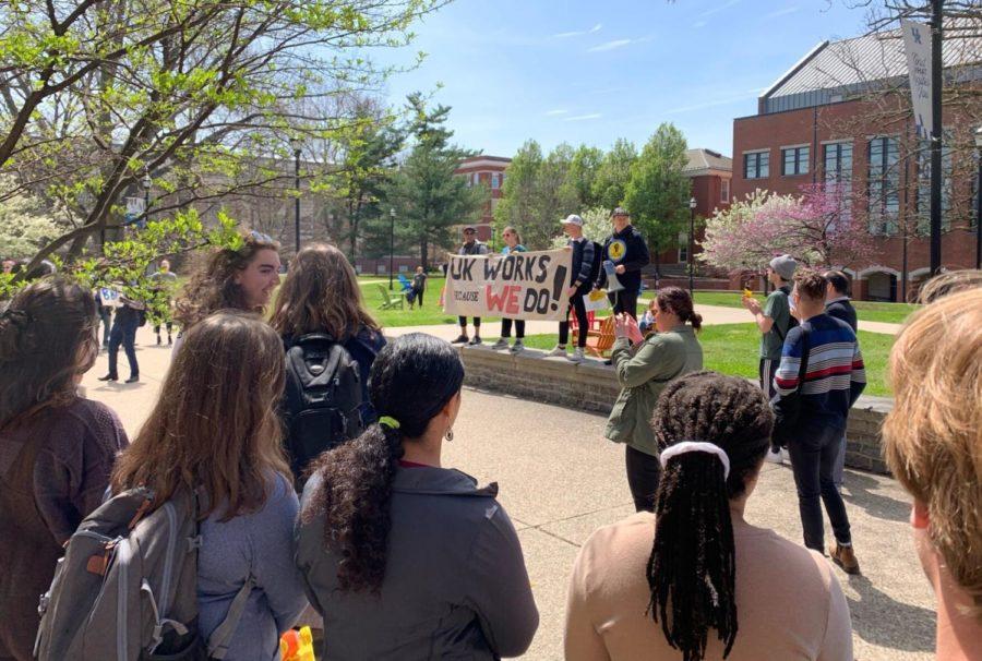 Demonstrators hold a banner outside White Hall Classroom Building during a rally organized by United Campus Workers of Kentucky on Wednesday, April 20, 2022, at the University of Kentucky in Lexington, Kentucky.
