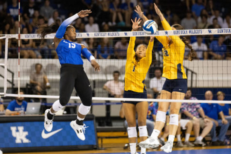 Kentucky Wildcats middle blocker Azhani Tealer (15) hits the ball during the Kentucky vs. Marquette volleyball match on Friday, Aug. 26, 2022, at Memorial Coliseum in Lexington, Kentucky. Marquette won 3-2. Photo by Jack Weaver | Staff