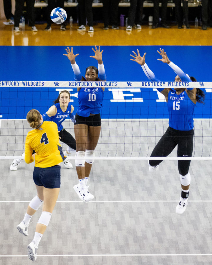 Kentucky Wildcats opposite Reagan Rutherford (10) and middle blocker Azhani Tealer (15) attempt to block a hit during the Kentucky vs. Marquette volleyball match on Friday, Aug. 26, 2022, at Memorial Coliseum in Lexington, Kentucky. Marquette won 3-2. Photo by Jack Weaver | Staff