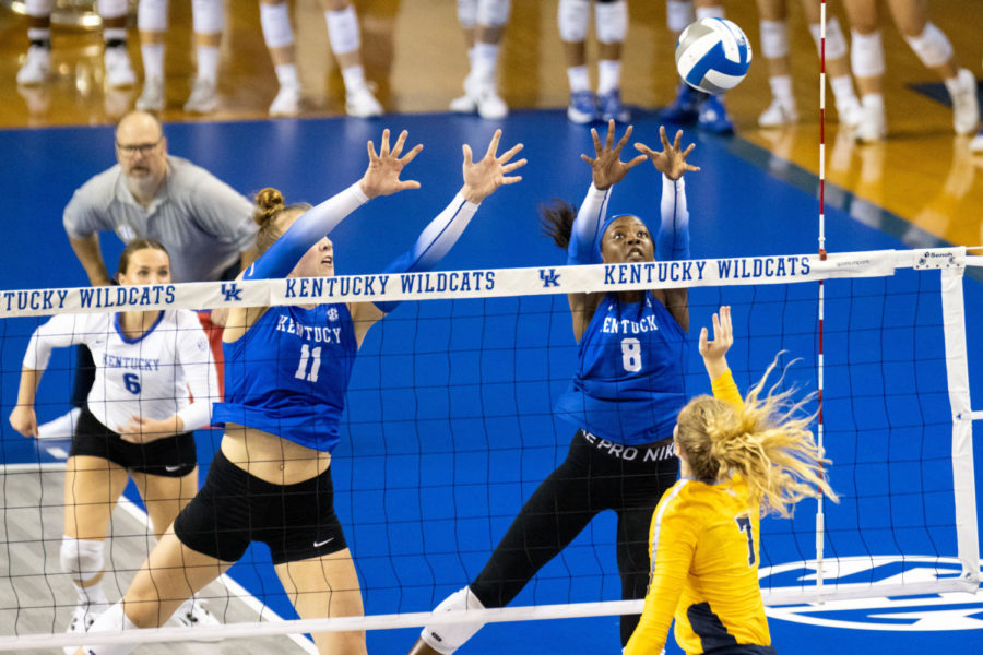 Kentucky Wildcats middle blocker Elise Goetzinger (11) and outside hitter Adanna Rollins (8) attempt to block a hit during the Kentucky vs. Marquette volleyball match on Friday, Aug. 26, 2022, at Memorial Coliseum in Lexington, Kentucky. Marquette won 3-2. Photo by Jack Weaver | Staff