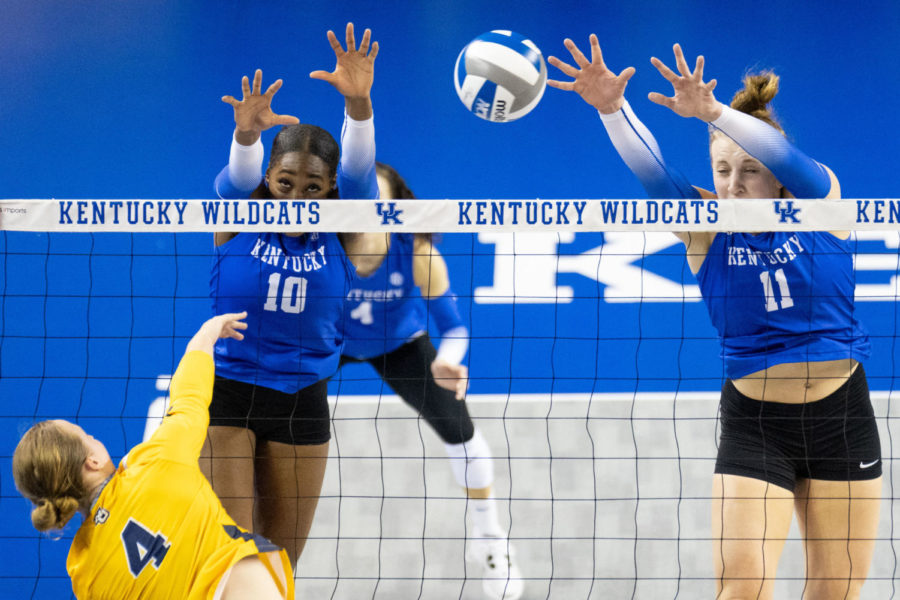 Kentucky Wildcats opposite Reagan Rutherford (10) and middle blocker Elise Goetzinger (11) attempt to block a hit during the Kentucky vs. Marquette volleyball match on Friday, Aug. 26, 2022, at Memorial Coliseum in Lexington, Kentucky. Marquette won 3-2. Photo by Jack Weaver | Staff