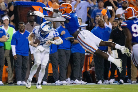 Kentucky Wildcats quarterback Will Levis (7) dodges a tackle from Florida Gators linebacker Brenton Cox Jr. (1) during the No. 20 Kentucky vs. No. 12 Florida football game on Saturday, Sept. 10, 2022, at Ben Hill Griffin Stadium in Gainesville, Florida. UK won 26-16. Photo by Jack Weaver | Staff