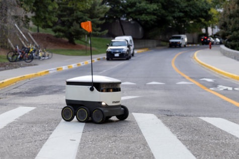 A Starship robot crosses a road on Tuesday, Sept. 13, 2022, at the University of Kentucky in Lexington, Kentucky. Photo by Jack Weaver | Kentucky Kernel