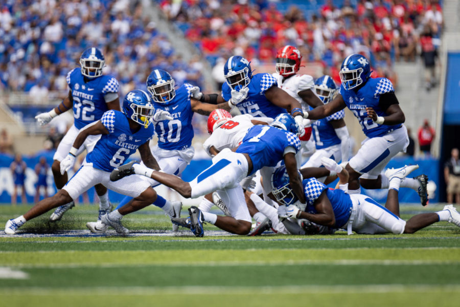 Youngstown State Penguins running back Jaleel McLaughlin (8) is tackled by a group of Kentucky players during the No. 9 Kentucky vs. Youngstown State football game on Saturday, Sept. 17, 2022, at Kroger Field in Lexington, Kentucky. UK won 31-0. Photo by Jack Weaver | Staff