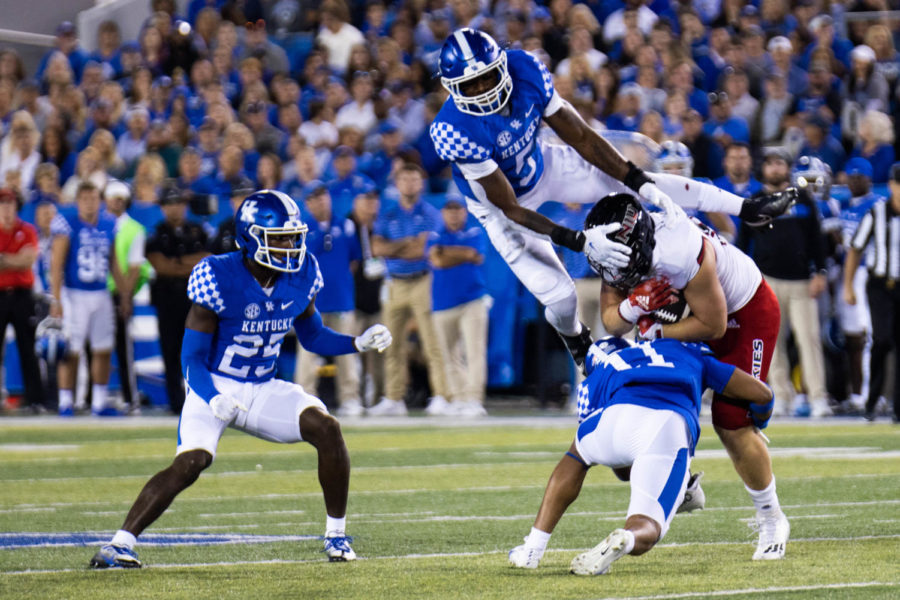 Kentucky Wildcats linebacker DeAndre Square (5) jumps over an NIU player during the No. 8 Kentucky vs. Northern Illinois football game on Saturday, Sept. 24, 2022, at Kroger Field  in Lexington, Kentucky. Kentucky won 31-23. Photo by Abby Szydlik | Staff