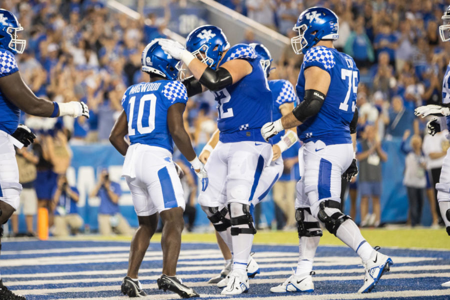A Kentucky player congratulates Kentucky Wildcats wide receiver Chauncey Magwood (10) during the Kentucky vs. Miami Ohio football game on Saturday, Sept. 3, 2022, at Kroger Field in Lexington, Kentucky. Photo by Isabel McSwain | Staff