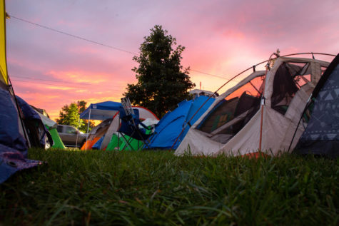 The sun sets behind rows of tents during the Tent City Live event outside Memorial Coliseum on Thursday, Sept. 27, 2018, in Lexington, Kentucky. Fans campout in order to have the chance to claim free Big Blue Madness tickets. Photo by Jordan Prather | Kentucky Kernel