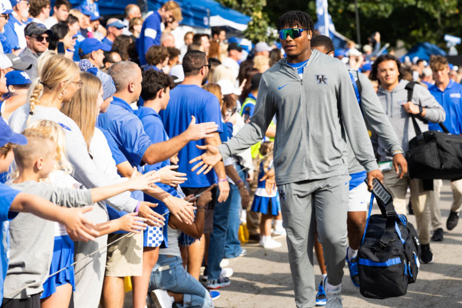 A Kentucky player high fives a fan during the Cat Walk before the No. 8 Kentucky vs. Northern Illinois football game on Saturday, Sept. 24, 2022, at Kroger Field in Lexington, Kentucky. Photo by Abby Szydlik | Staff
