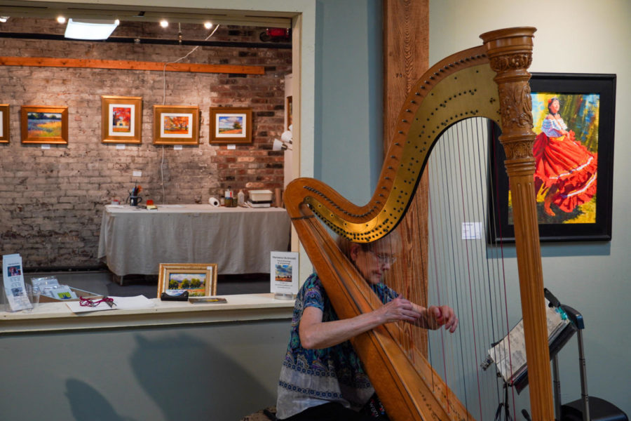 A woman plays the harp on Friday, Sept. 16, 2022, at the Lex Arts Hop in Lexington, Kentucky. Photo by Bryce Towle | Staff
