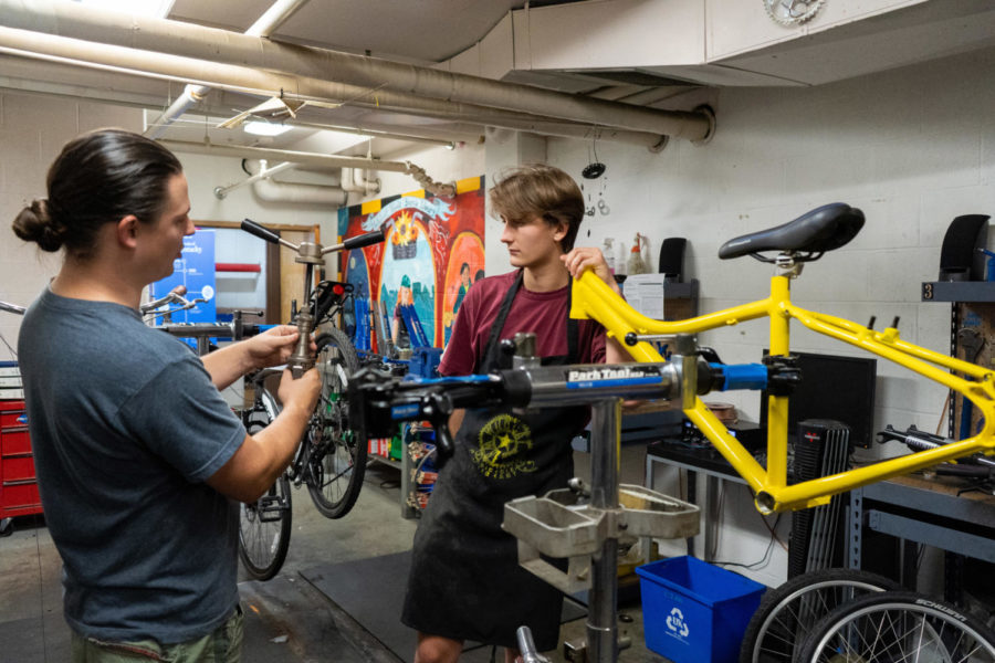 Shop manager William Varney demonstrates to mechanic Alex Grence how to use a specific tool on Wednesday, Sept. 21, 2022, at Wildcat Wheels Bicycle Library in Lexington, Kentucky. Photo by Carter Skaggs | Kentucky Kernel