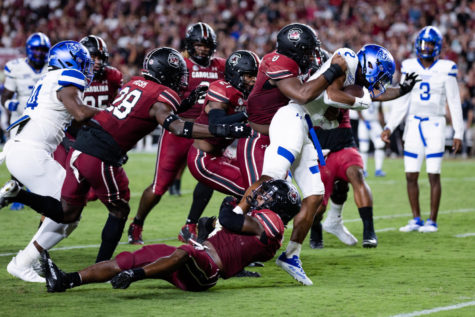 A group of South Carolina Gamecocks players make a tackle during the South Carolina vs. Georgia State football game on Saturday, Sept. 3, 2022, at Williams-Brice Stadium in Columbia, South Carolina. Photo by Sydney Dunlap | Daily Gamecock