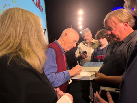 Astronaut Story Musgrave signs a copy of his book on Thursday, Oct. 13, 2022, at the University of Kentucky’s Student cenetr Worsham Cinema in Lexington, Kentucky. Photo by Alexis Baker | Kentucky Kernel