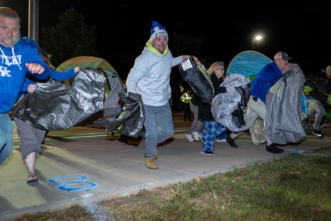 Campers rush to throw down their tents and blankets to claim a space on the lawn of Memorial Coliseum on Saturday, Oct. 1, 2022, in Lexington, Kentucky. Photo by Carter Skaggs | Staff