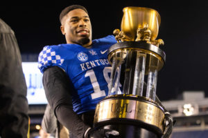 Kentucky Wildcats wide receiver Chauncey Magwood (10) carries the Governor’s Cup trophy after the Kentucky vs. No. 25 Louisville football game on Saturday, Nov. 26, 2022, at Kroger Field in Lexington, Kentucky. UK won 26-13. Photo by Isabel McSwain | Staff