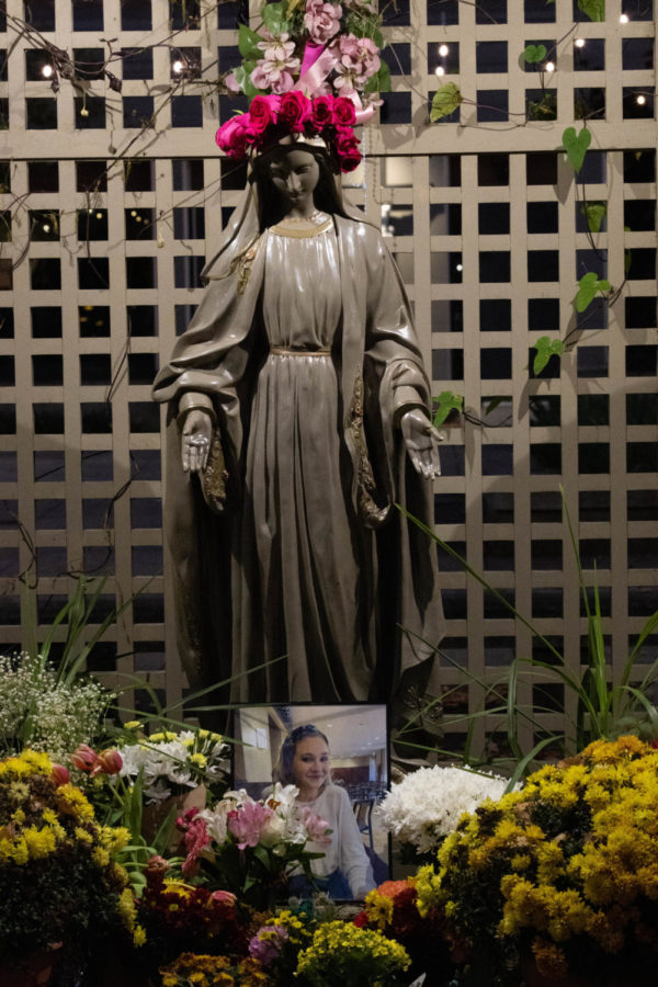 A photo of Anne Marie Gieske rests with flowers under the Mary statue on Thursday, Nov. 3, 2022, at the Catholic Newman Center in Lexington, Kentucky. Photo by Abbey Cutrer | Staff
