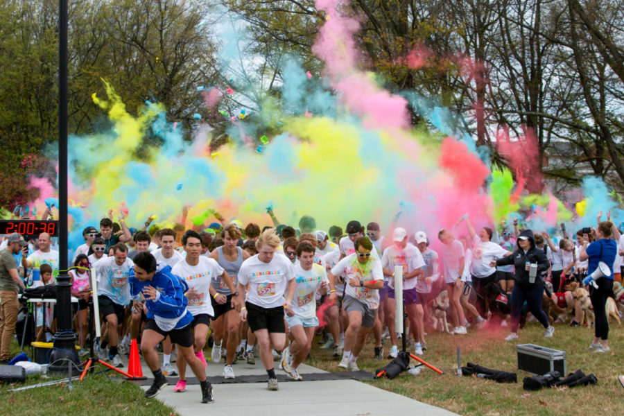 Color is thrown over runners at the DanceBlue Color Me Blue 5K on Saturday, Nov. 5, 2022, at the University of Kentucky in Lexington, Kentucky. Photo by Travis Fannon | Kentucky Kernel
