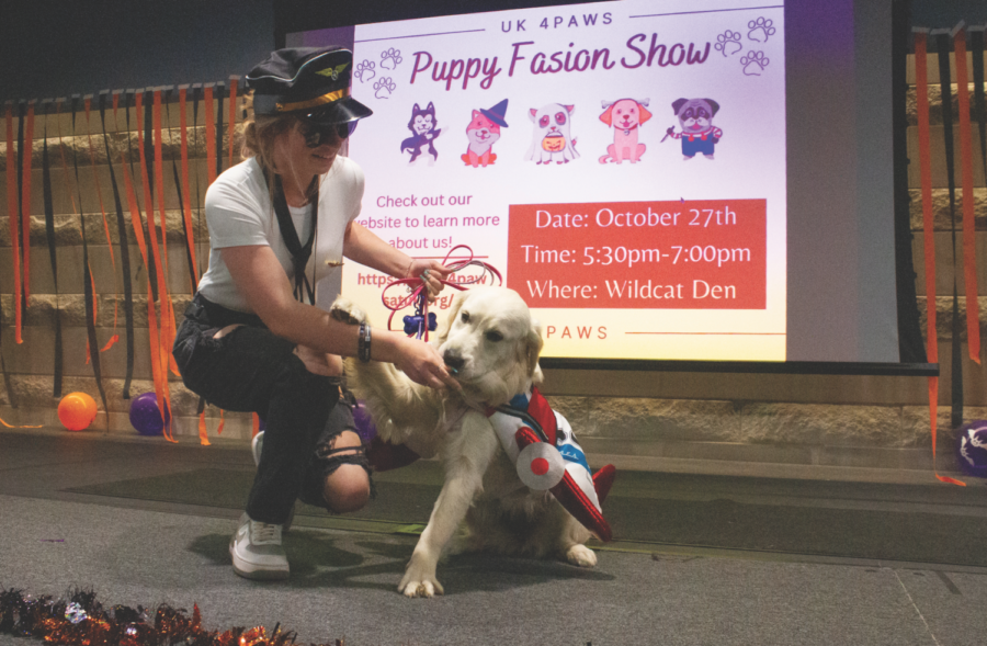 Handler Megan Smith and dog Airlie dress up as a pilot and an airplane for the Puppy Fashion Show on Thursday, Oct. 27, 2022, in the Cats Den at The University of Kentucky in Lexington, Kentucky. Photo by Maria Rauh | Staff