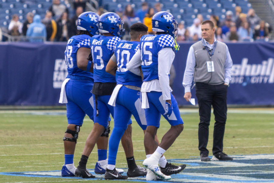 Kentucky captains walk onto the field for the coin toss before the Kentucky vs. Iowa Music City Bowl football game on Saturday, Dec. 31, 2022, at Nissan Stadium in Nashville, Tennessee. UK lost 21-0. Photo by Travis Fannon | Staff