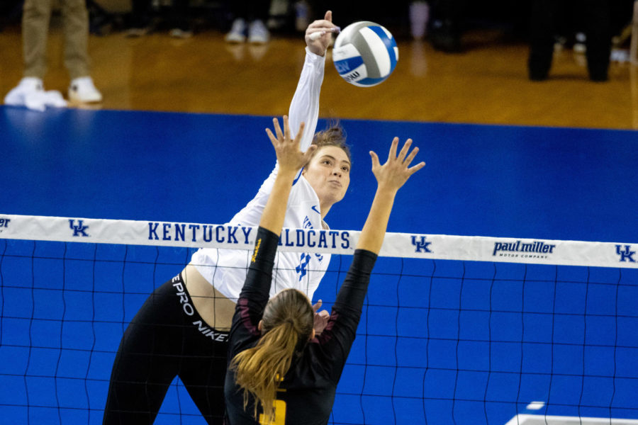 Kentucky Wildcats middle blocker Bella Bell (14) hits the ball over the net during the No. 3 Kentucky vs. Loyola Chicago volleyball match in the first round of the NCAA Tournament on Thursday, Dec. 1, 2022, at Memorial Coliseum in Lexington, Kentucky. UK won 3-0. Photo by Olivia Hall | Staff