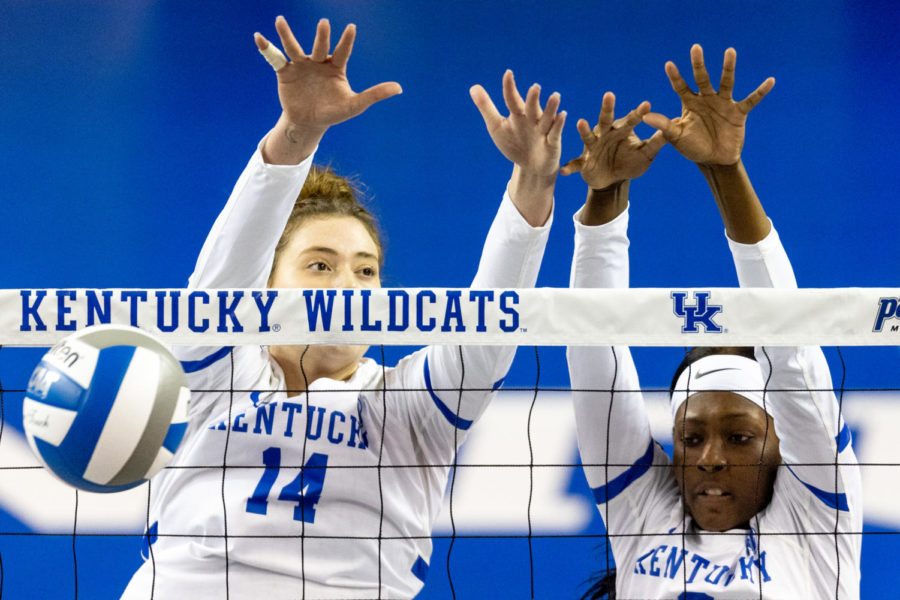 Kentucky Wildcats middle blocker Bella Bell (14) and outside hitter Adanna Rollins (8) block the ball during the No. 3 Kentucky vs. Loyola Chicago volleyball match in the first round of the NCAA Tournament on Thursday, Dec. 1, 2022, at Memorial Coliseum in Lexington, Kentucky. UK won 3-0. Photo by Jack Weaver | Staff