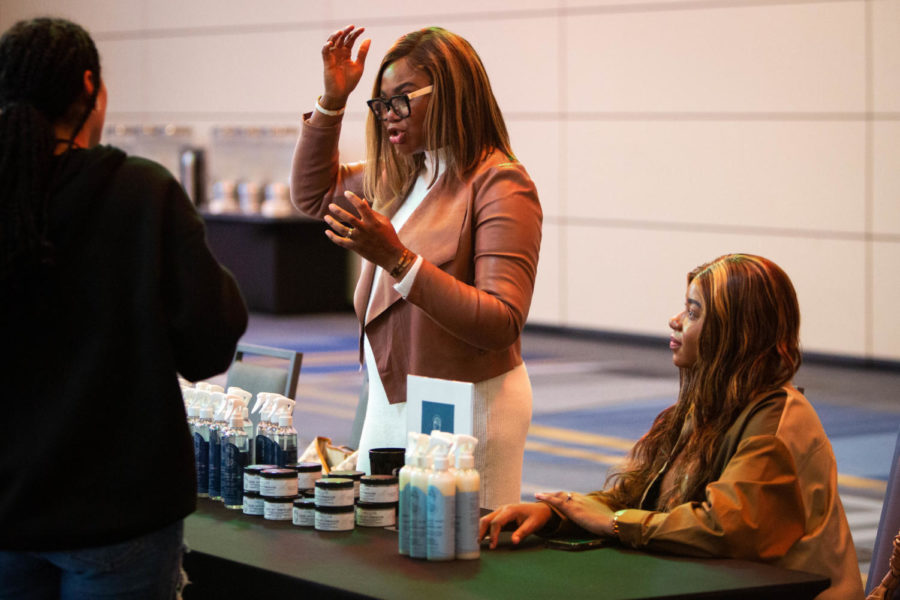 Students visit the Tina Braids booth at the Natural Hair Care Expo on Thursday, Feb. 9, 2023, at the Gatton Student Center in Lexington, Kentucky. Photo by Samuel Colmar | Staff