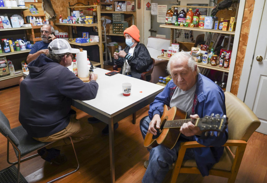 Ed Henson plays guitar for Bald Knob Little Market locals in Frankfort, Kentucky on Thursday, Oct. 6, 2022. Photo by Bryce Towle.