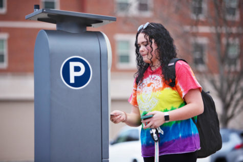 Ashlee Bell, a junior marketing major, pays for parking outside William T. Young Library on Tuesday, Feb. 7, 2023, in Lexington, Kentucky. Photo by Samuel Colmar | Staff