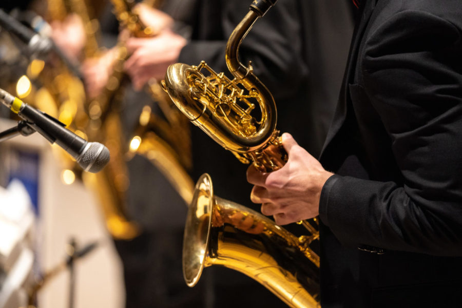 A UK Lab Band saxophonist plays into the microphone during the Jazzy Valentine’s Concert on Tuesday, Feb. 14, 2023, at Singletary Center for the Arts in Lexington, Kentucky. At the concert, both the UK Lab Band and UK Jazz Ensemble performed. Photo by Carter Skaggs | Staff