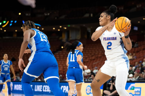 Florida Gators forward Tatyana Wyche (2) throws the ball at Kentucky Wildcats forward Ajae Petty (13) during an altercation in the Kentucky vs. Florida womens basketball game in the first round of the SEC Tournament on Wednesday, March 1, 2023, at Bon Secours Wellness Arena in Greenville, South Carolina. Wyche, along with six other players, was ejected. Petty received a technical foul. Photo by Carter Skaggs | Staff