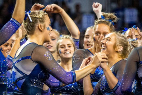 Kentucky celebrates after junior Hailey Davis’ floor routine during the No. 12 Kentucky vs. No. 9 Auburn gymnastics meet on Saturday, March 4, 2023, at Memorial Coliseum in Lexington, Kentucky. Kentucky won 197.675-196.450. Photo by Samuel Colmar | Staff