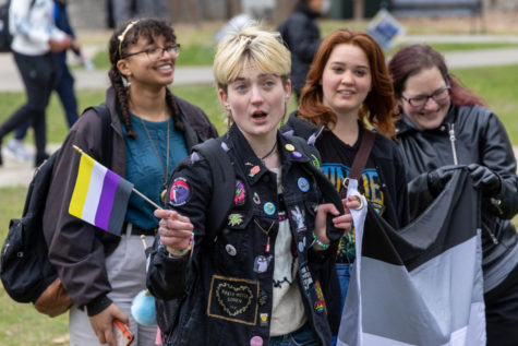 Z Frizzell, a freshman geoscience major, holds a nonbinary flag in response to an anti-LGBTQ on-campus demonstration on Wednesday, March 8, 2023, at the University of Kentucky in Lexington, Kentucky. Photo by Travis Fannon | Staff
