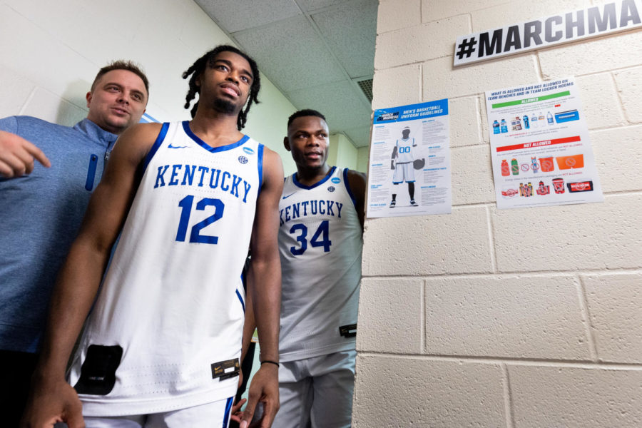 Kentucky Wildcats guard Antonio Reeves (12) and forward Oscar Tshiebwe (34) walk into the locker room after the No. 6 Kentucky vs. No. 11 Providence mens basketball game in the first round of the NCAA Tournament on Friday, March 17, 2023, at Greensboro Coliseum in Greensboro, North Carolina. Kentucky won 61-53. Photo by Jack Weaver | Staff