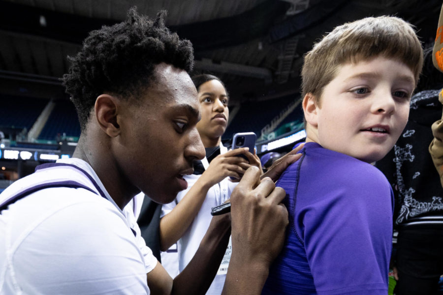 Kansas State Wildcats forward NaeQwan Tomlin (35) signs a fan’s shirt during the No. 6 Kentucky vs. No. 3 Kansas State mens basketball game in the second round of the NCAA Tournament on Sunday, March 19, 2023, at Greensboro Coliseum in Greensboro, North Carolina. Kansas State won 75-69. Photo by Jack Weaver | Staff